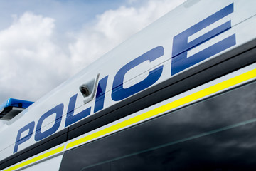 Large POLICE sign on side of patrol vehicle. © John Gomez