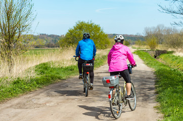 Fototapeta premium Older people ride a bike in the park