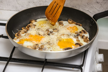 Fried eggs with mushrooms for a breakfast