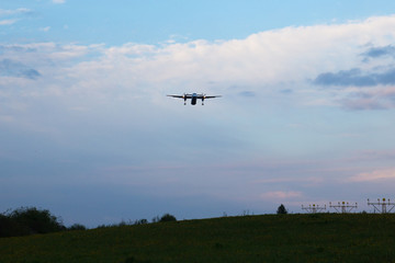 The plane lands at dusk
