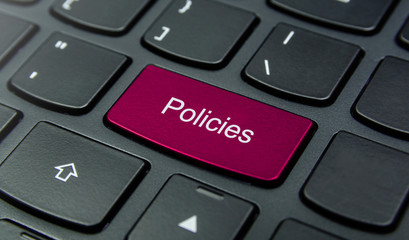 Close-up the Policies button on the keyboard and have Pink color button isolate black keyboard