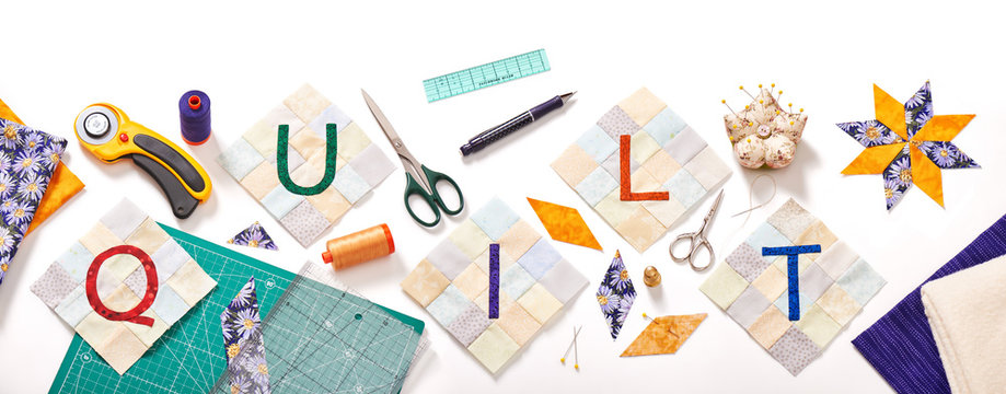 sewn letters, consisting to the word quilt surrounded by accessories for patchwork