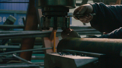 Men's hands screwing the milling cutter