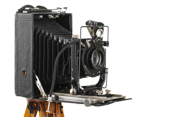 Old camera on a tripod on a white background