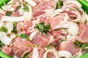 Fresh raw meat and onion sliced and marinated for shish kebab with parsley and spices