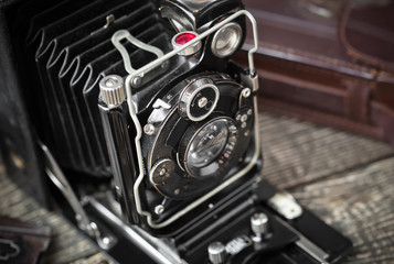 Old camera on an old background on a close-up table