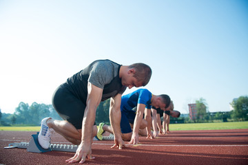 Runners preparing for race at starting blocks