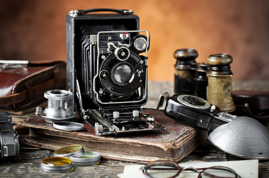 Old camera on an old background on a close-up table