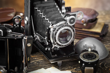 Old camera on a tripod on an old background close-up