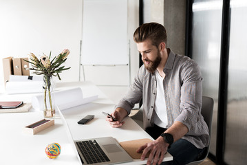 Fototapeta premium Busy office worker using phone