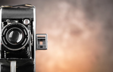 Old camera on an old background on a close-up table