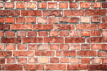 Detailed red brick background. Wall of red damaged blocks. Dirty stone pattern
