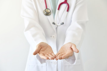 Doctor presenting blank palm of her hand, Close up of female doctor holding something.