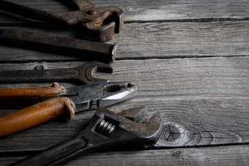 Dirty set of hand tools on a wooden background. Old rusty tools. Equipment for locksmith and metalworking shop. Sales tools for assembly workers.  Old shop Old working tools. Vintage working tools (dr