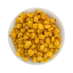 Toasted corn nuts in a small bowl isolated on a white background top view.