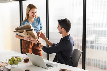 Jolly smiling manager holding documents