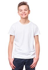 White t-shirt on teen boy. Handsome caucasian smiling child, isolated on a white background. Concept of childhood and fashion or advertisement design. Mock up template for design print. - 150117529