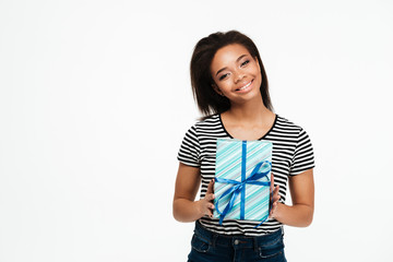 Portrait of a young afro american woman holding present box