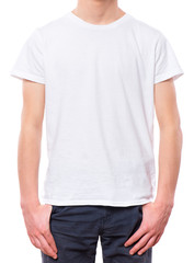 White t-shirt on teen boy. Close-up of front tshirt, isolated on a white background. Concept of childhood and fashion or advertisement design. Mock up template for design print. 