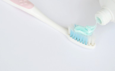 squeeze toothpaste put on toothbrush in white background