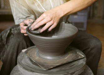Fototapeta na wymiar Potter making a clay pot, handmade, selective focus