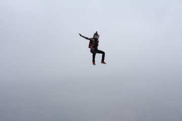 Fototapeta na wymiar Skydiver girl in the sky