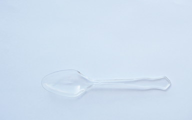 clear and translucent plastic spoon on white background