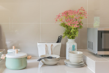 kitchen counter with ceramic bowl, pot, plates