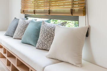 row of pillows on modern wooden bench