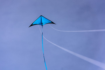 Blue kite floating in the blue sky. Kite with blue sky background.