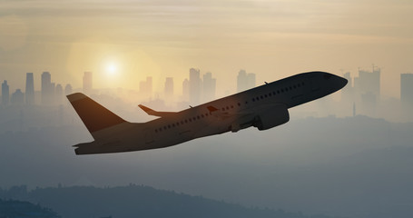 Airplane taking off and the city