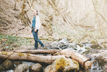 Woman crossing a river.