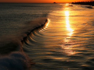 Wave breaking at sunset
