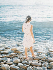 Woman walking on shore.
