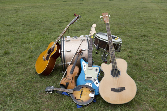 various musical instruments piled up on the ground