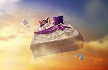 girl is flying in her bed - obrazy, fototapety, plakaty