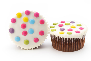Multiple colorful decorated muffins on a white background.