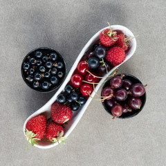 Fresh summer berries in bowls. Top view.