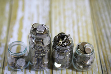 coins stacked in glass jars on the floor russian rubles