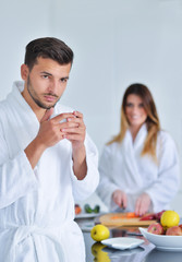 Happy couple cooking breakfast together in the kitchen