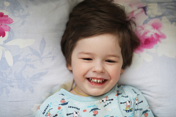 Portrait of a young child lying on a pillow