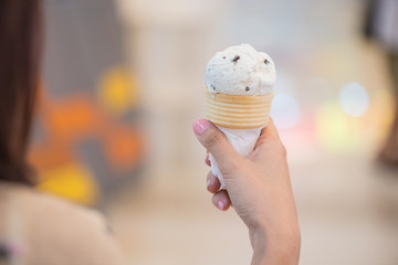 woman's hand holding an ice cream