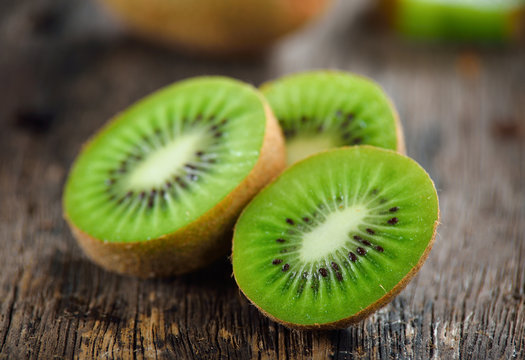 sliced kiwi fruit on wooden background