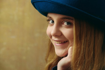 happy smiling girl in retro blue hat and blonde hair