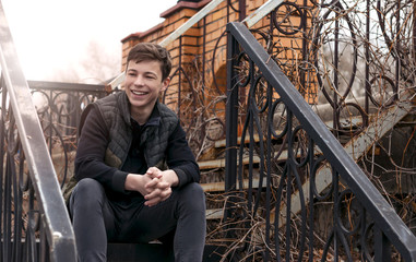 emotional young man sitting on the stairs