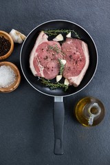 Sirloin chop in frying pan with ingredients