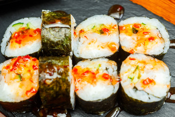 Spicy sushi rolls with sweet honey sauce