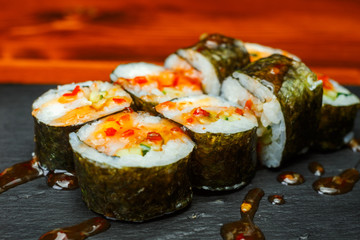 Spicy sushi rolls with sweet honey sauce