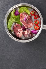 Sirloin chops and ingredients in frying pan
