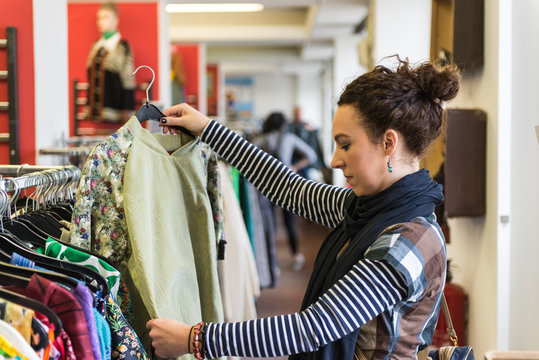Woman browsing through vintage Thrift Store  clothing 